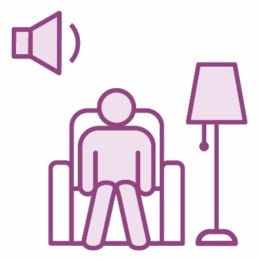 A person sitting in an armchair next to a standing lamp and a low volume icon.