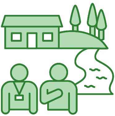 A person wearing a lanyard supporting someone. There is a mountain, trees, a river and a house behind them.