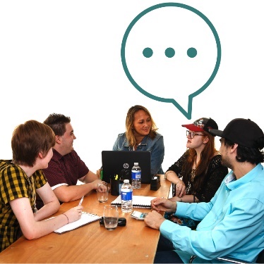 A group of people having a meeting at a table.