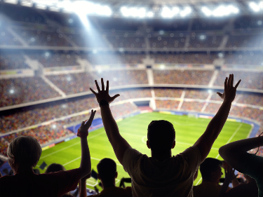 People watching sport in a stadium.