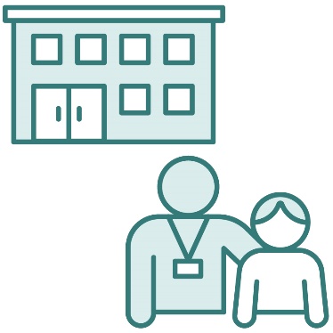 A person wearing a lanyard supporting a child in front of a building.