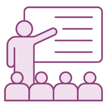 A classroom with a teacher pointing to a whiteboard and teaching students.