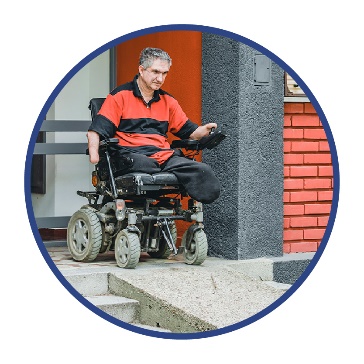 A person in a wheelchair using a ramp in the community.