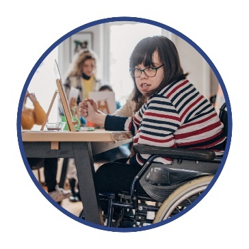 A person with disability taking part in a community art class.
