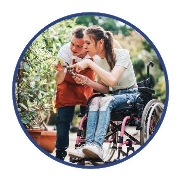 A person with disability working in a garden with someone.