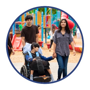 A person with disability and their family at a playground. 