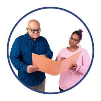 A person supporting someone to read a document.